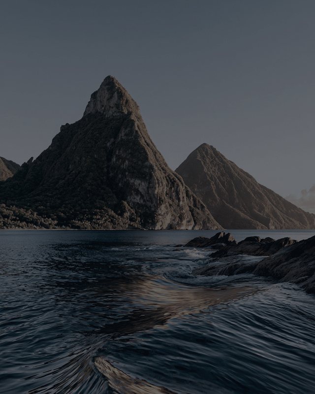 The Pitons and the sea at low light, drained of colour.
